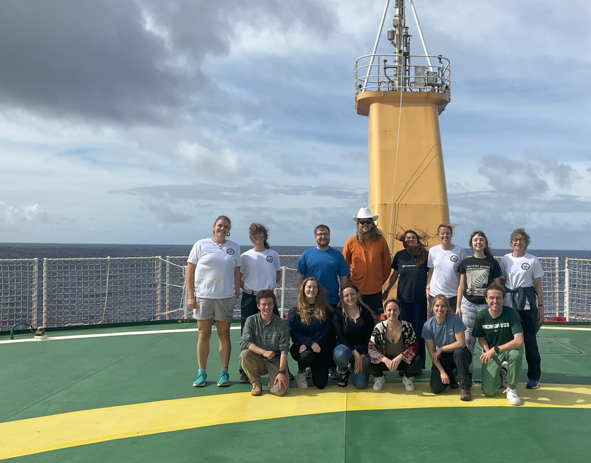 A group of people on the helideck of a ship