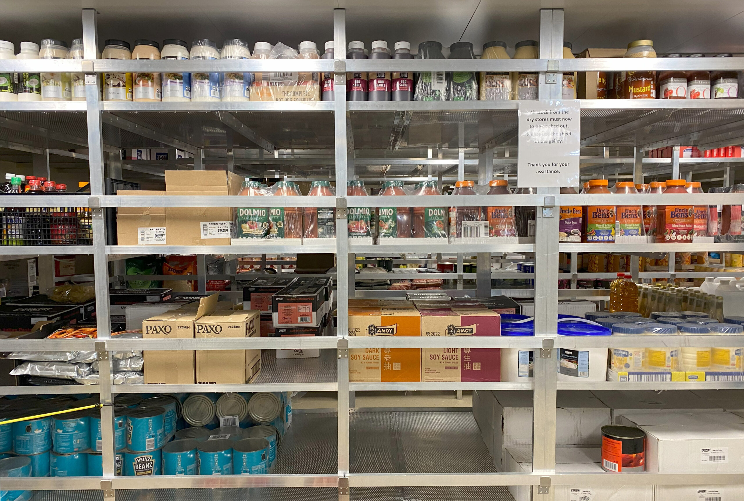 Metal shelves full of large jars of food