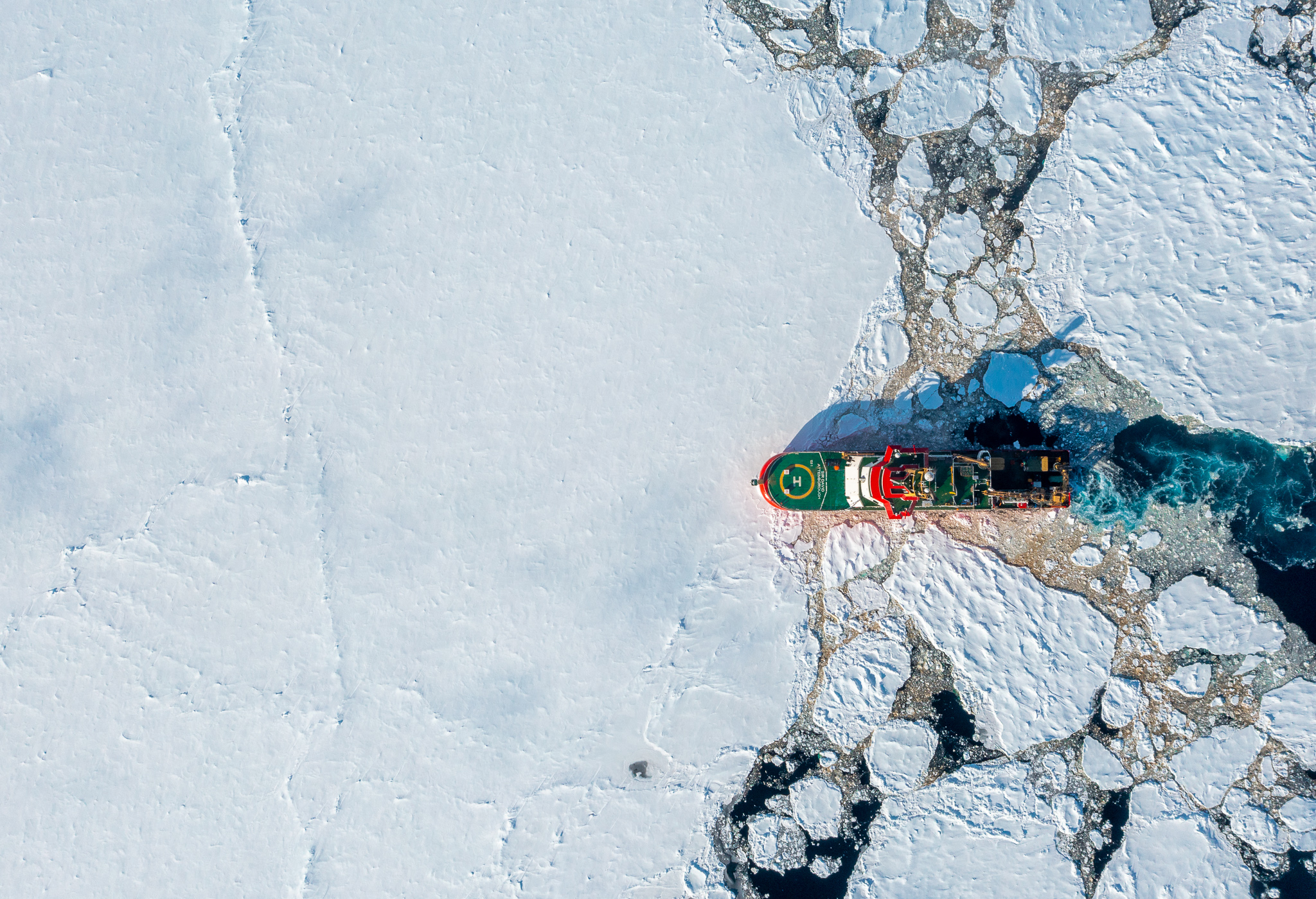 A drone image of a ship in sea ice