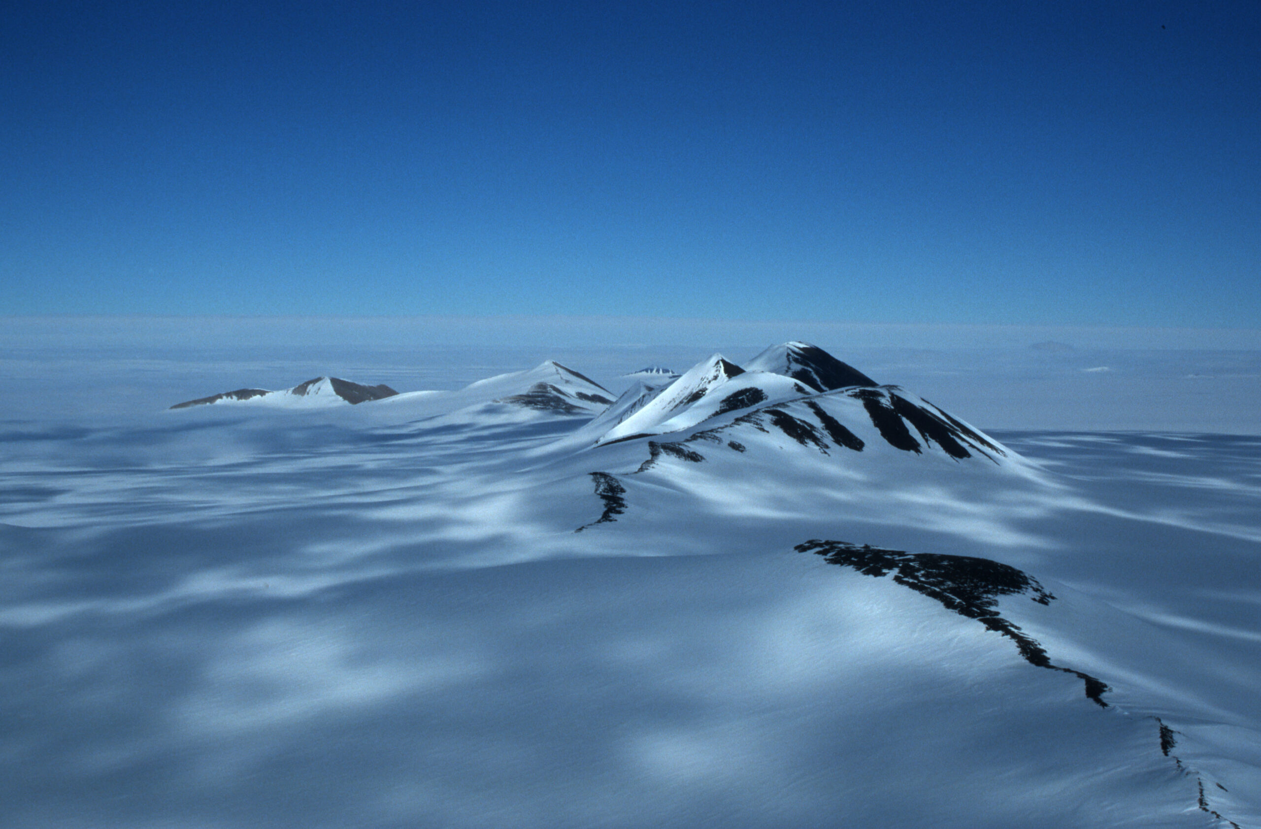 Snowy mountain peaks rising above the snow