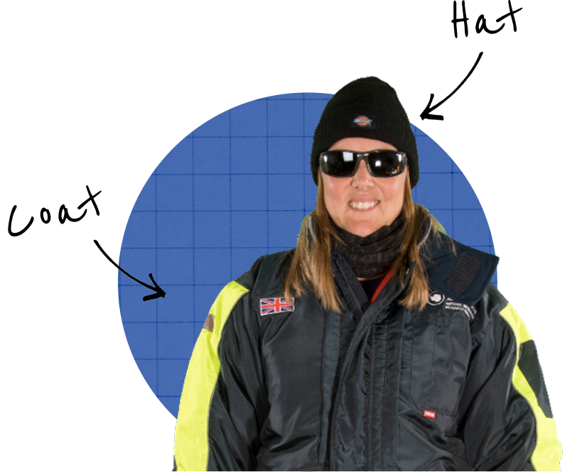 A woman smiling at the camera wearing a hat, coat and gloves