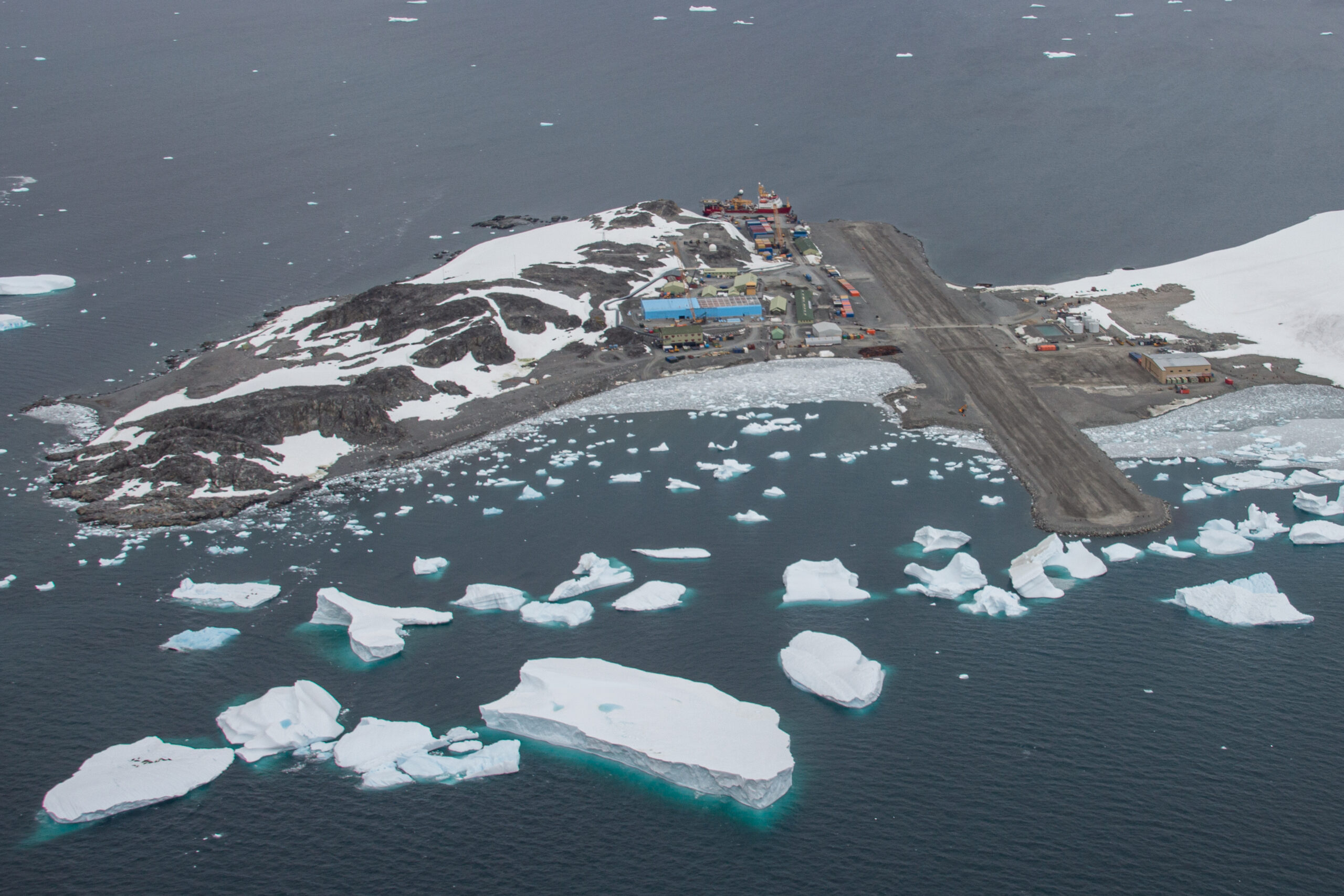 An aerial view of Rothera, the blue Discovery Building is clearly visible, as is the runway