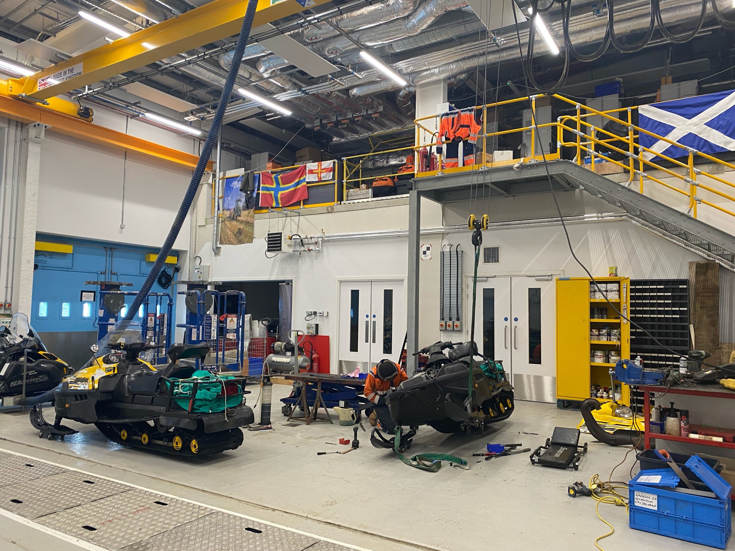 A vehicle workshop full of tools and a skidoo being repaired