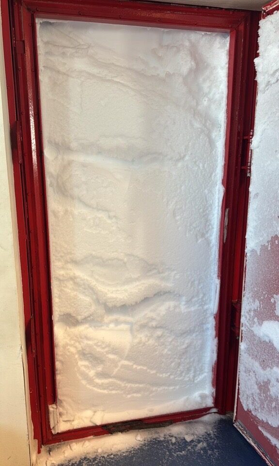 A doorway completely full of snow