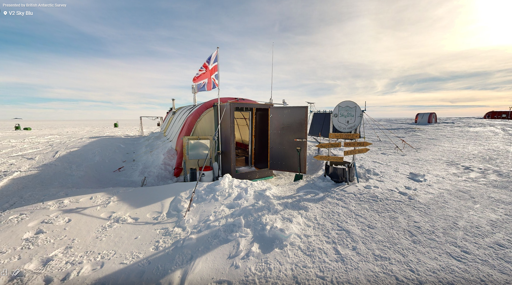 A long, arch shaped tent with an open door