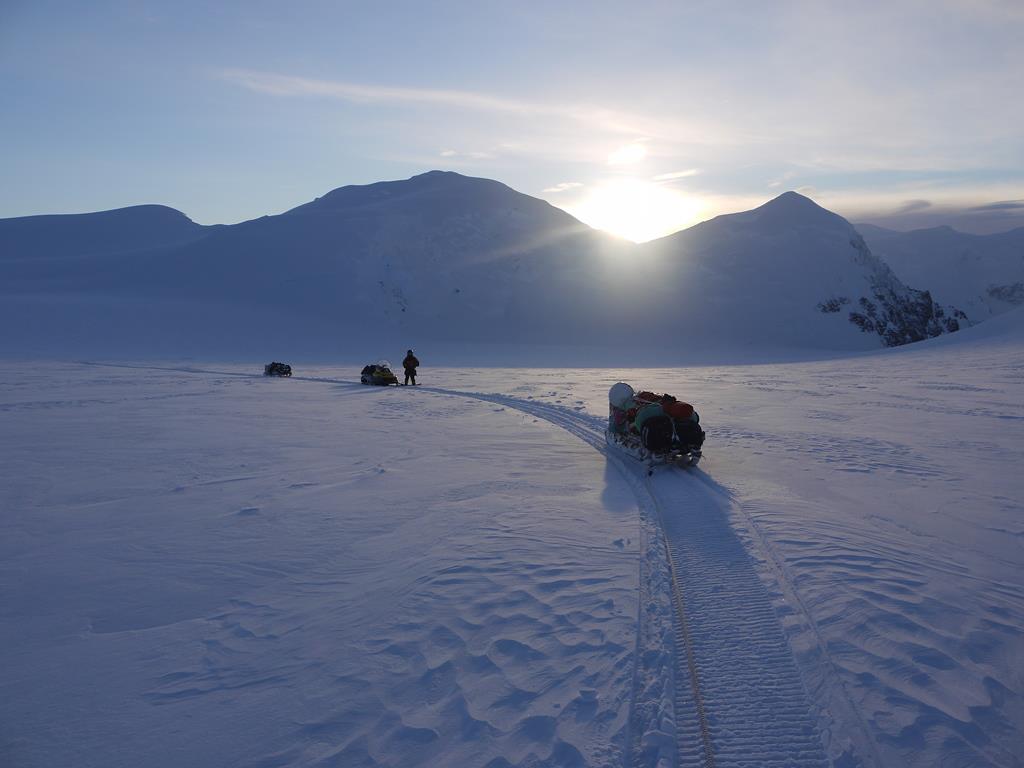 Skidoos in a snowy landscape